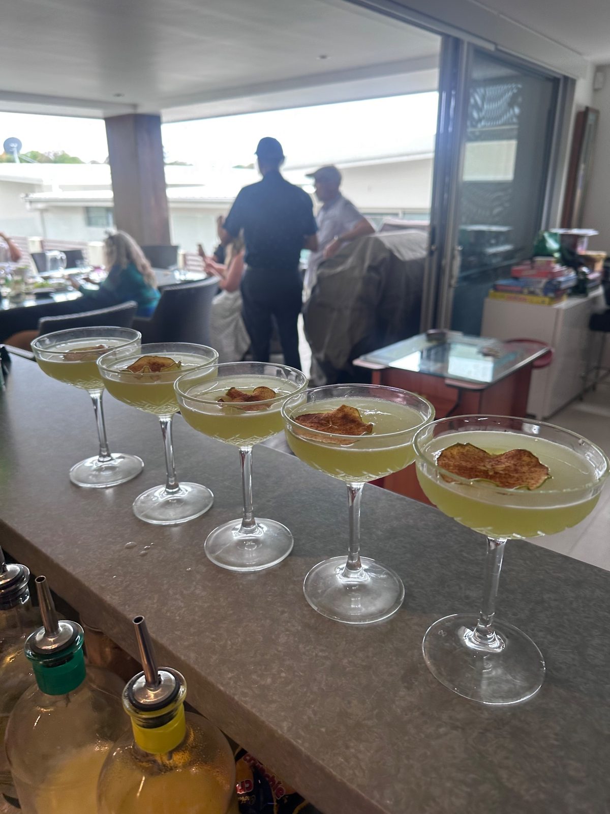 A Jimmy Slings bartender working the bar on board, Sydney harbour behind