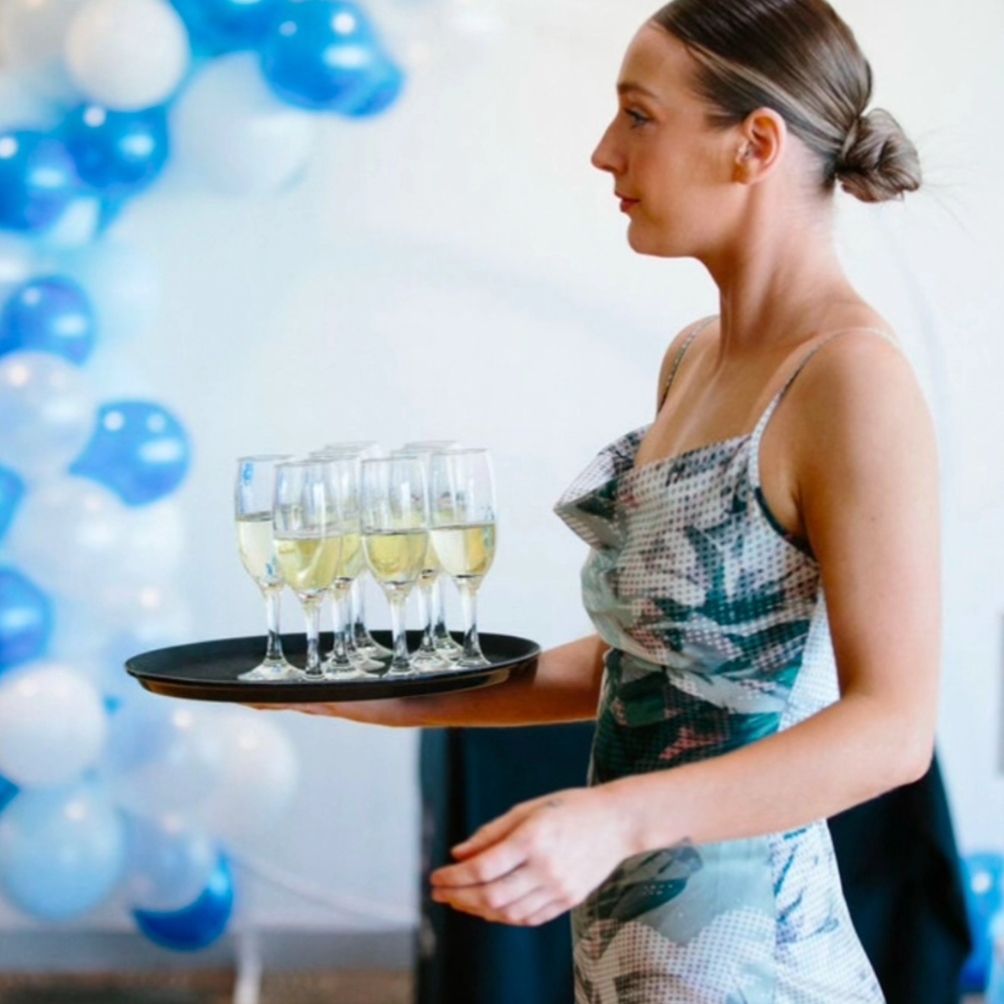 Champagne tray gliding through a party