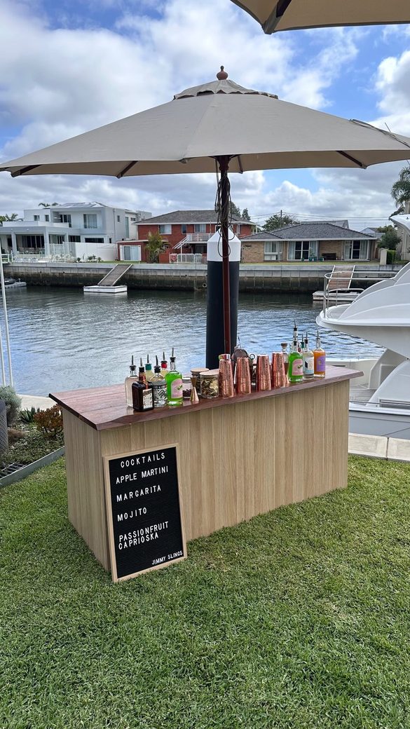 A backyard party on the lawn with the drinks table set up