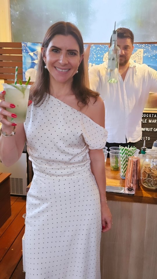 A guest with a fresh green cocktail